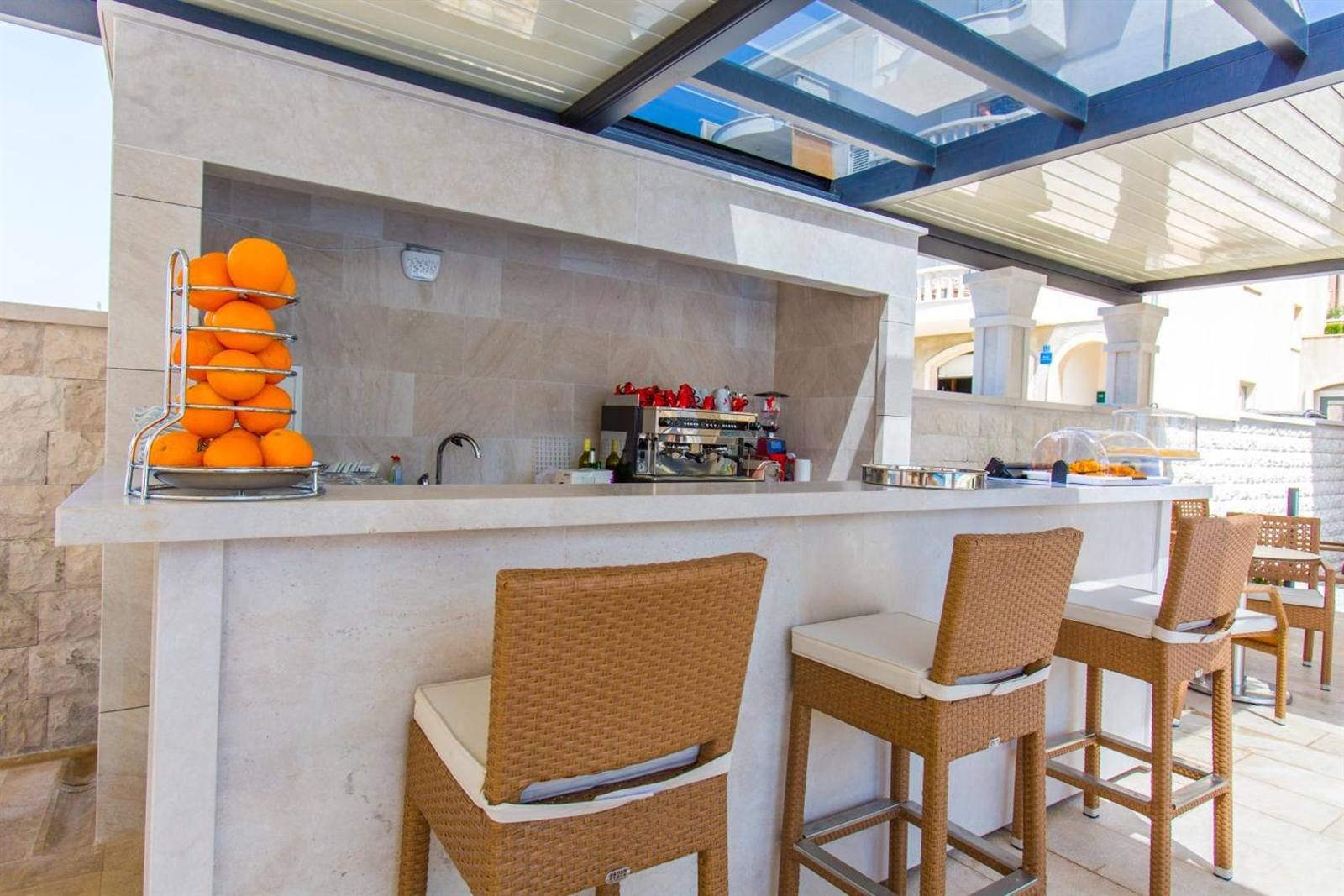 Luxury Aparthotel: the pool bar with stools and a fruit display