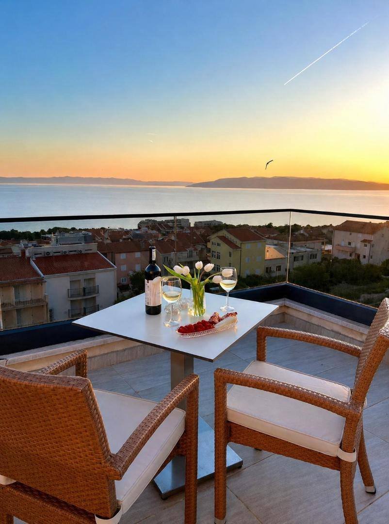 Luxury Aparthotel: balcony table set for two at sunset, with sea views